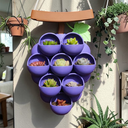 3D-printed grape pots in purple, brown, and green. V1195-VYY0067