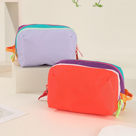 Dopamine Color-Blocking Cosmetic Bag, waterproof with large capacity, layered storage for skincare and makeup, easy opening and closing with drawstring zipper, essential sweet storage item for travel and commuting./(front) light purple (back) bright orang