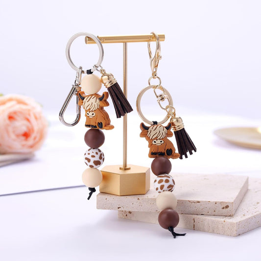 Kvekstio Cute Highland Cow Keychain, 2 Pack Farm Animal Cow Print Silicone Bead Key Ring with Tassel Gift for V1258-DP02-B-1107