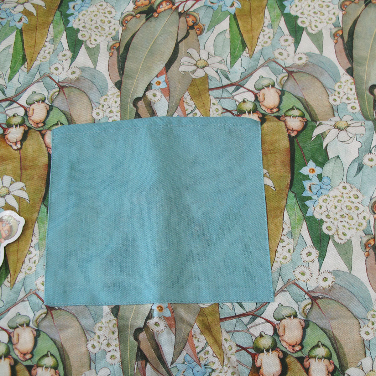 May Gibbs Gumnut Baby Cotton Apron 60 x 85 cm V442-JTC-APRON-GUMNUTBABY-MULTI-SH